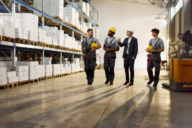 istock Senior inspector making plans with warehouse workers on the move. 1997447605