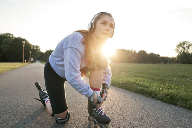 istock Woman preparing to rollerblade in the park 1997452121