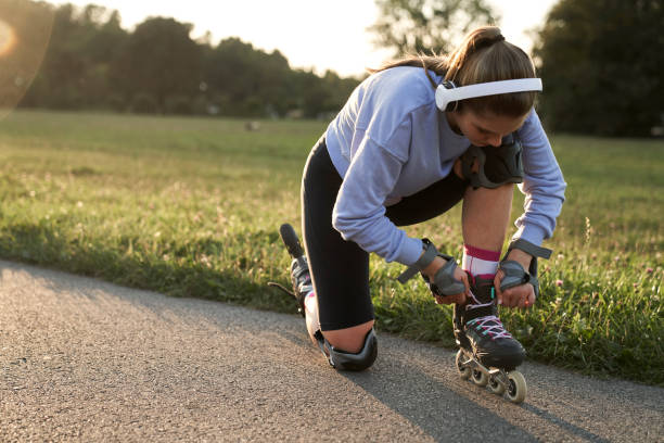 istock Woman preparing to rollerblade in the park 1997452633