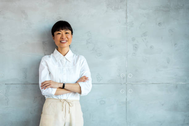 istock Successful businesswoman standing in modern office with copy space. 1997462678