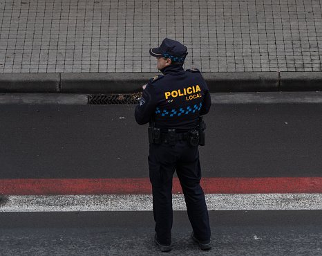Local policeman from Spain looking at his left side