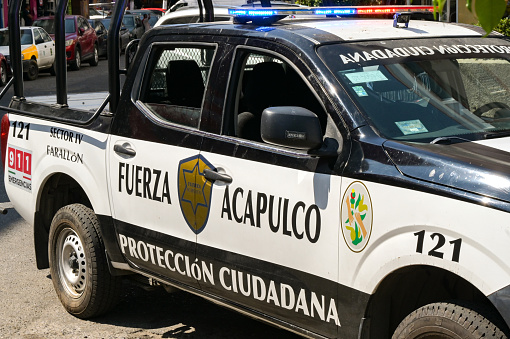 Acapulco, Mexico - 17 January 2024: Police force patrol truck with emergency lights flashing in the centre of Acapulco