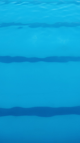 blue background of the swimming pool with rows of swimming lanes