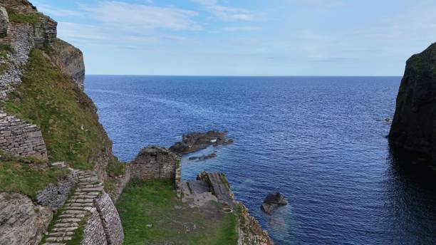 istock steps down to the water from the cliff face, and steps leading up 1997489635