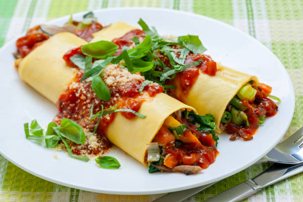 istock Traditional cannelloni with minced meat, tomatoes and sauce. 1997512025