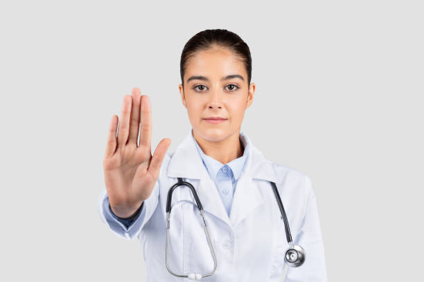istock Serious young european doctor with a stethoscope gesturing 'stop' with her hand 1997512055