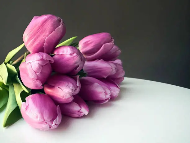 Pink tulips flowers bouquet on table. Waiting for spring. Happy Easter, Mother's day.