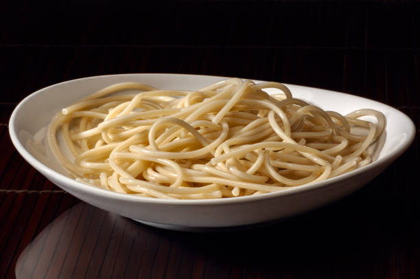 White plate of cooked spaghetti