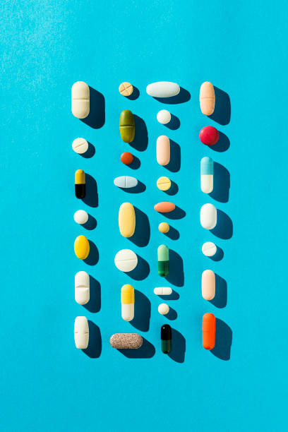 istock Colorful medicine, tablets, pills and capsules on blue background 1997532675