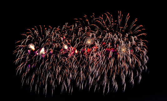 Colorful celebration fireworks isolated on a night black sky background.