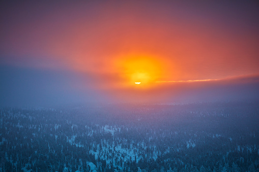 Sun breaks through the clouds on a very cold morning in Saariselka