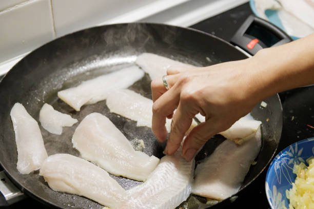 istock Fish in sauce with shrimp. Step by step preparation. Grilling the fish 1997550927