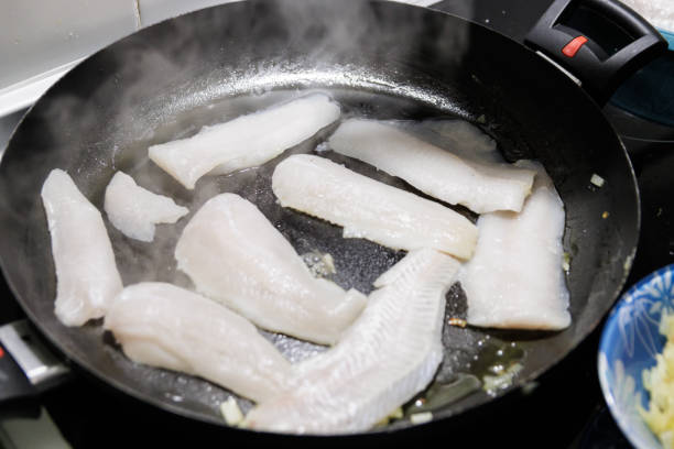 istock Fish in sauce with shrimp. Step by step preparation. Grilling the fish 1997551470