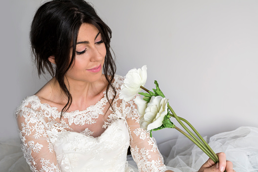 Beautiful bride in wedding with bouquet of white flowers