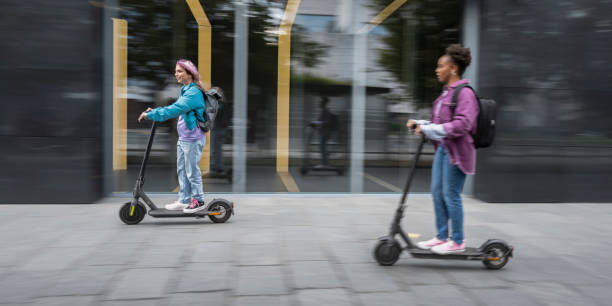 istock Two Friends Riding Electric Scooter. Blurred Motion 1997574263