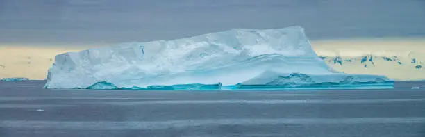 Photo of Flat top iceberg seperated from an ice shelf with caves, Paradise Bay, Gerlach Straight, Antarctica