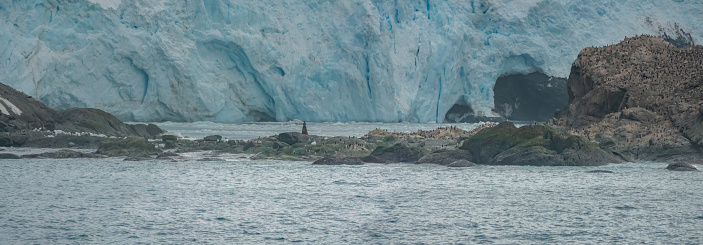 The incredibly inhospitable Shakleton's landing site on the shores of Elephant Island, Antarctica. Rocky outcrops inhabited by penguins