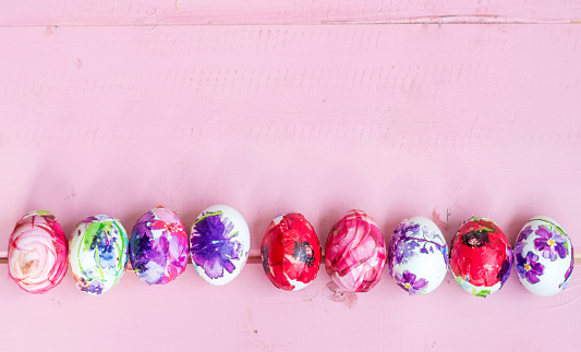 Easter eggs on pink wooden background