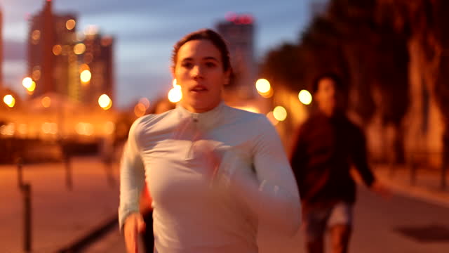 Urban Sprint: Millennial Woman Leads Friends in Fast Run Through City