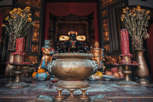 Picture of Buddha's Face lit from the side. The picture is isolated from the background and shows serenity and meditation.