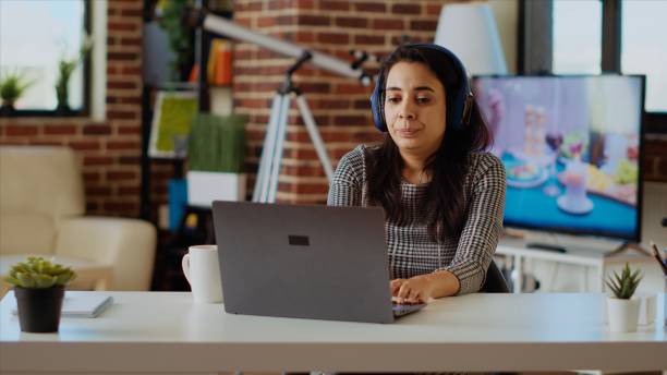 istock Woman wearing headphones answering HR interview questions during videoconference 1997612262