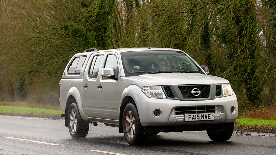 Milton Keynes,UK-Feb 9th 2024: 2015 silver Nissan Navara car  driving on an English road