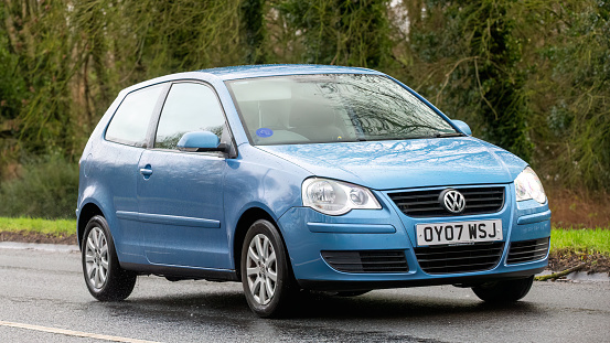 Milton Keynes,UK-Feb 9th 2024: 2007 blue Volkswagen Polo car  driving on an English road