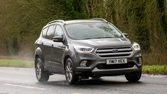 Milton Keynes,UK-Feb 9th 2024: 2017 grey diesel engine Ford Kuga car  driving on an English road