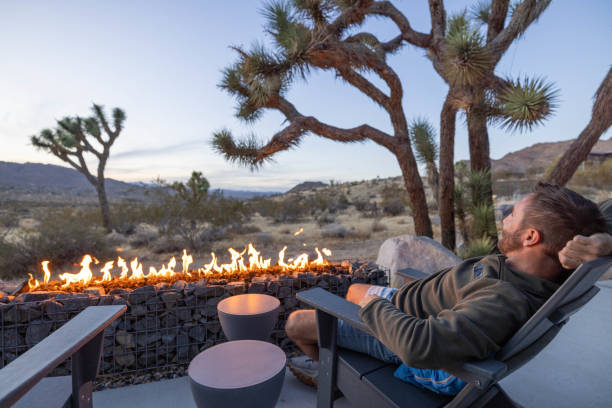 istock Twilight Serenity: A Young Man's Reflection by the Outdoor Fire Pit 1997625434