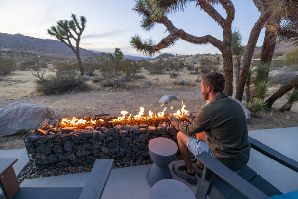istock Twilight Serenity: A Young Man's Reflection by the Outdoor Fire Pit 1997625947