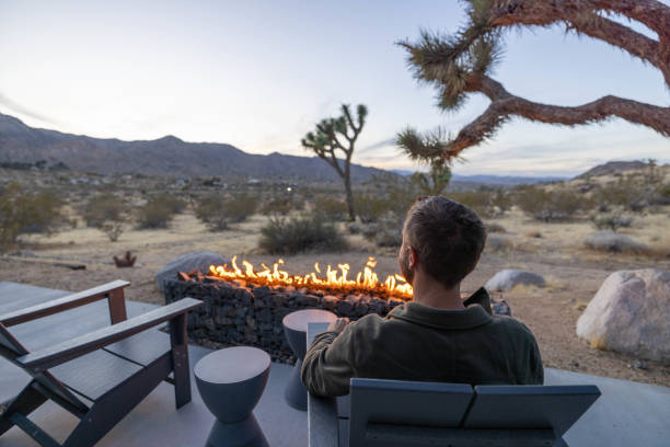 istock Twilight Serenity: A Young Man's Reflection by the Outdoor Fire Pit 1997627012