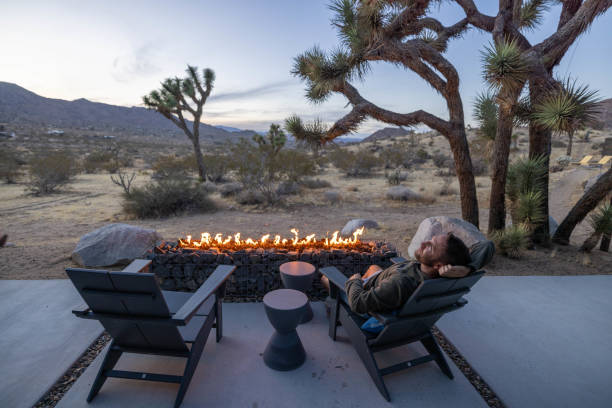 istock Young man by the fire pit outdoors at dusk 1997627560