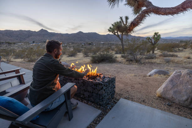 istock Twilight Serenity: A Young Man's Reflection by the Outdoor Fire Pit 1997627571