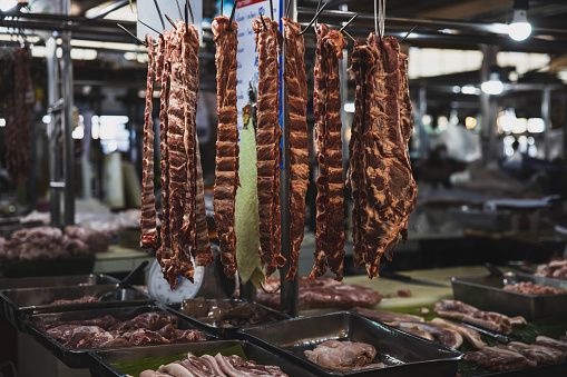 Sliced, ready-to-sell meats in an open-air butcher.