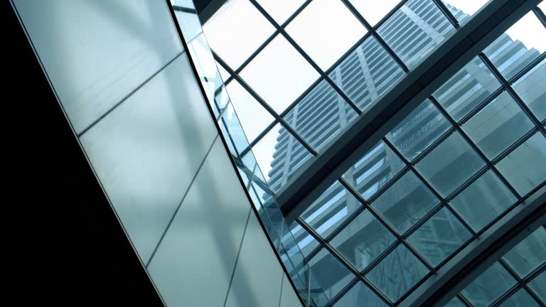 Transparent roof and metal ceiling beams with sunshine through the glasses. Commercial buildings.