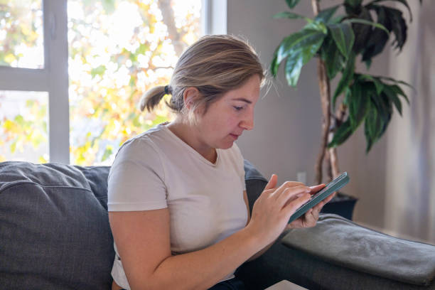 istock Young woman at home on her laptop 1997650774