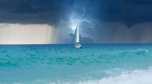 istock Sailing yacht in a stormy weather with thunder and lightning 1997652894