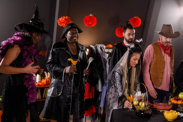 istock Group of friends serving drinks and snacks for a Halloween party 1997654508