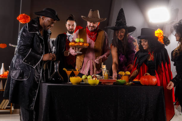 istock Group of friends serving drinks and snacks for a Halloween party 1997654512