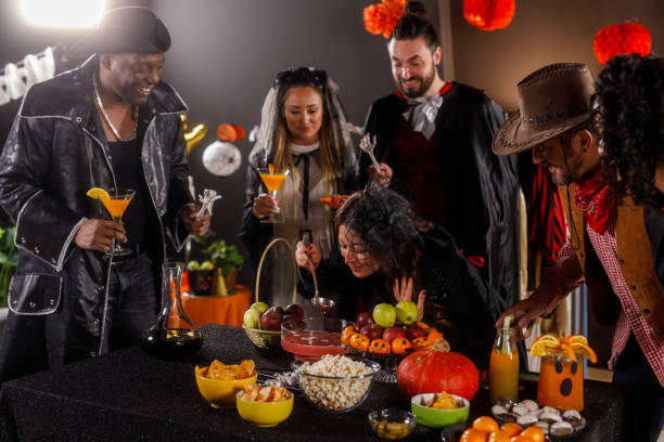 istock Group of friends serving drinks and snacks for a Halloween party 1997654514