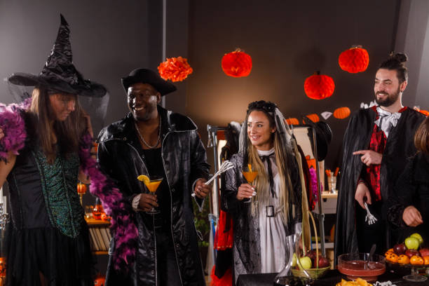 istock Group of friends serving drinks and snacks for a Halloween party 1997654522