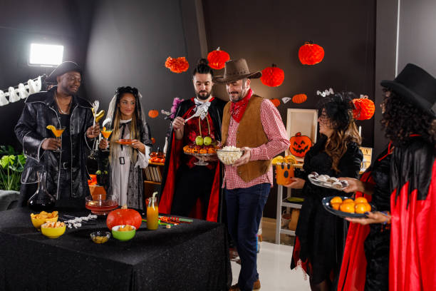 istock Group of friends serving drinks and snacks for a Halloween party 1997655577