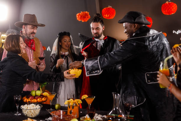 istock Friends enjoying drinks and snacks at the Halloween party 1997655608