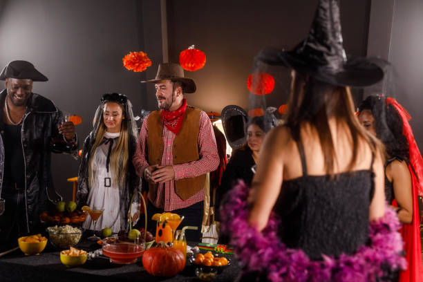 istock Serving red wine to enjoy during a fun Halloween party 1997655620