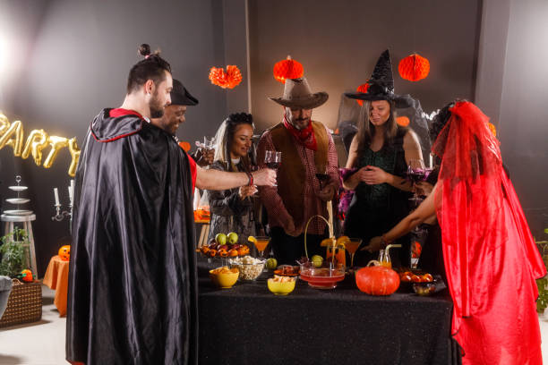 istock Serving red wine to enjoy during a fun Halloween party 1997656139