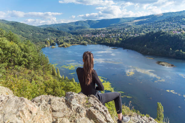 istock Woman standing above a lake 1997656155