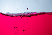 Fruit juice in a clear glass bottle There are white background bubbles..