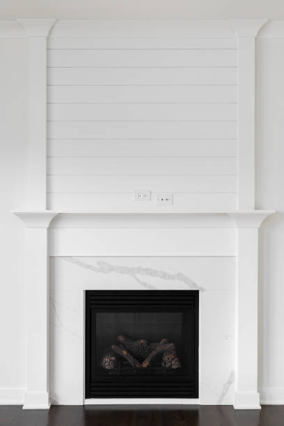 istock A fireplace detail with decorative trim, marble surround, and shiplap. 1997683057