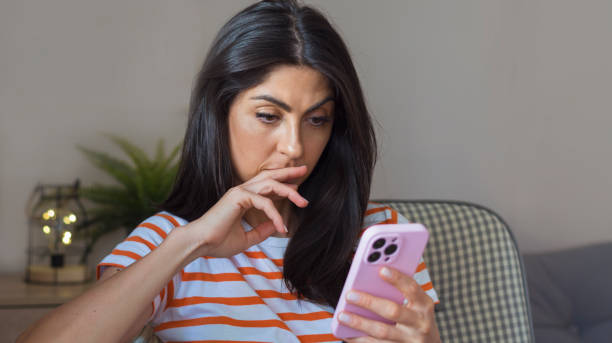istock Sad Woman  using her phone at home 1997694167