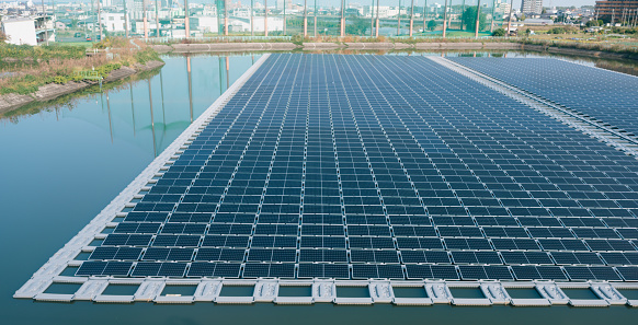 Aerial view of lake in floating solar panels cell platform on renewable alternative electricity Kyoto japan